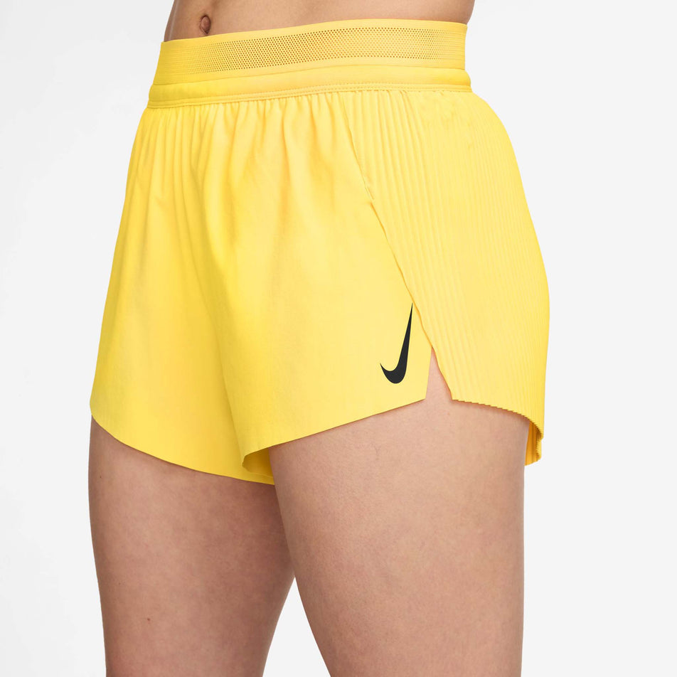 Angled view of a model wearing the Nike Women's AeroSwift Dri-FIT ADV Mid-Rise Brief-Lined 3