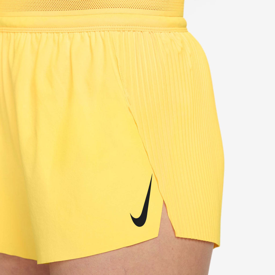 Angled view of a model wearing the Nike Women's AeroSwift Dri-FIT ADV Mid-Rise Brief-Lined 3