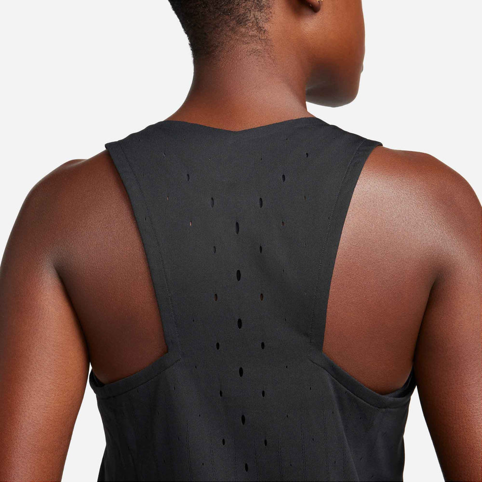 Back view of a model wearing a Nike Women's AeroSwift Dri-FIT ADV Running Singlet in the Black/White colourway. Upper part of singlet can be seen in the image. (8185995428002)