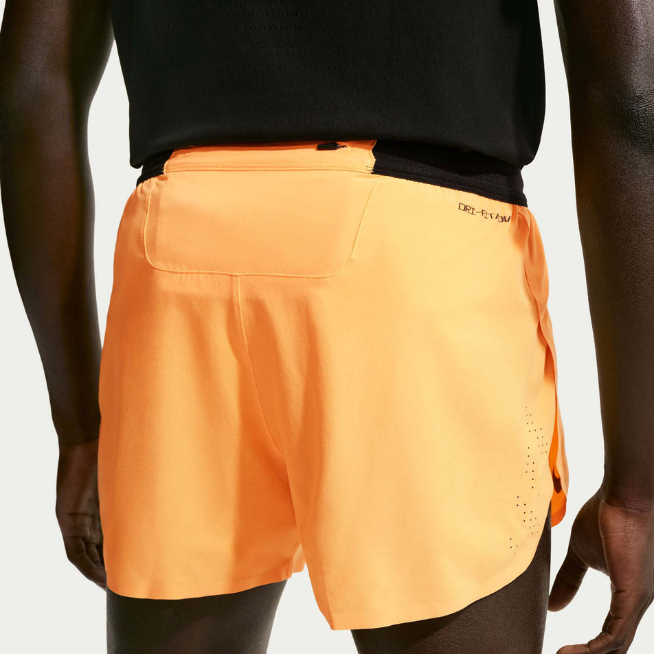 Back view of a model wearing the Nike Men's AeroSwift Dri-FIT ADV 4