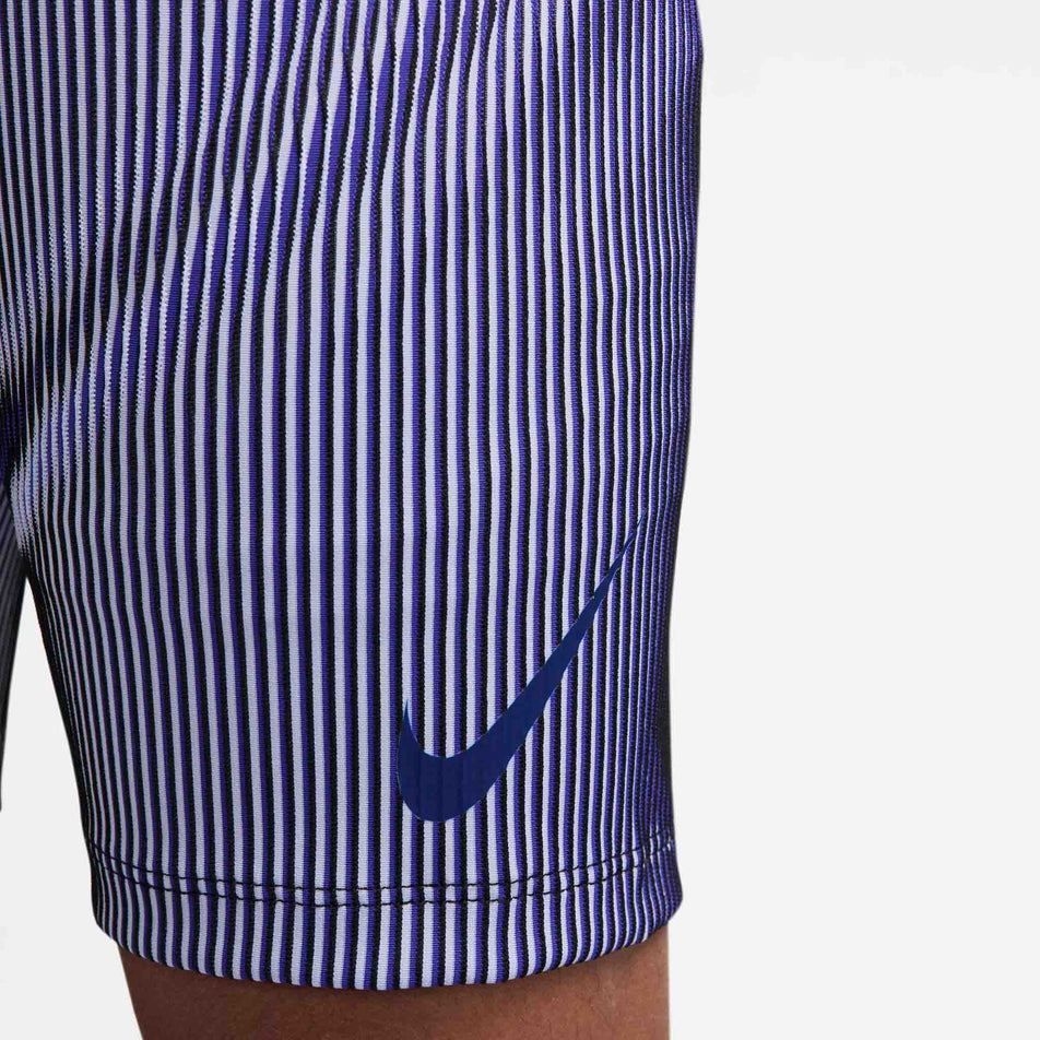 Close up of the Nike Swoosh on the front of the Nike Men's AeroSwift Dri-FIT ADV Running 1/2-Length Tights in the Vivid Purple/Black/Reflective colourway. (8692967669922)