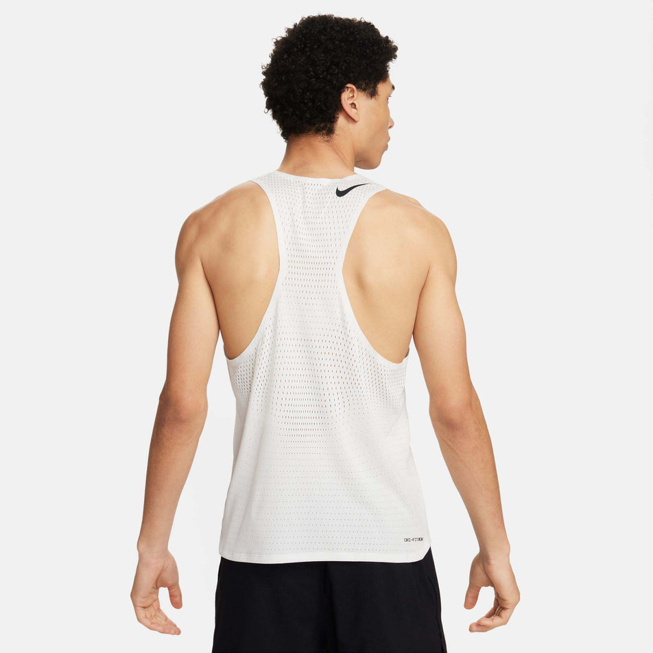 Back view of a model wearing a Nike Men's AeroSwift Dri-FIT ADV Running Singlet in the Summit White/Black colourway. Model is also wearing Nike shorts. (8186007322786)