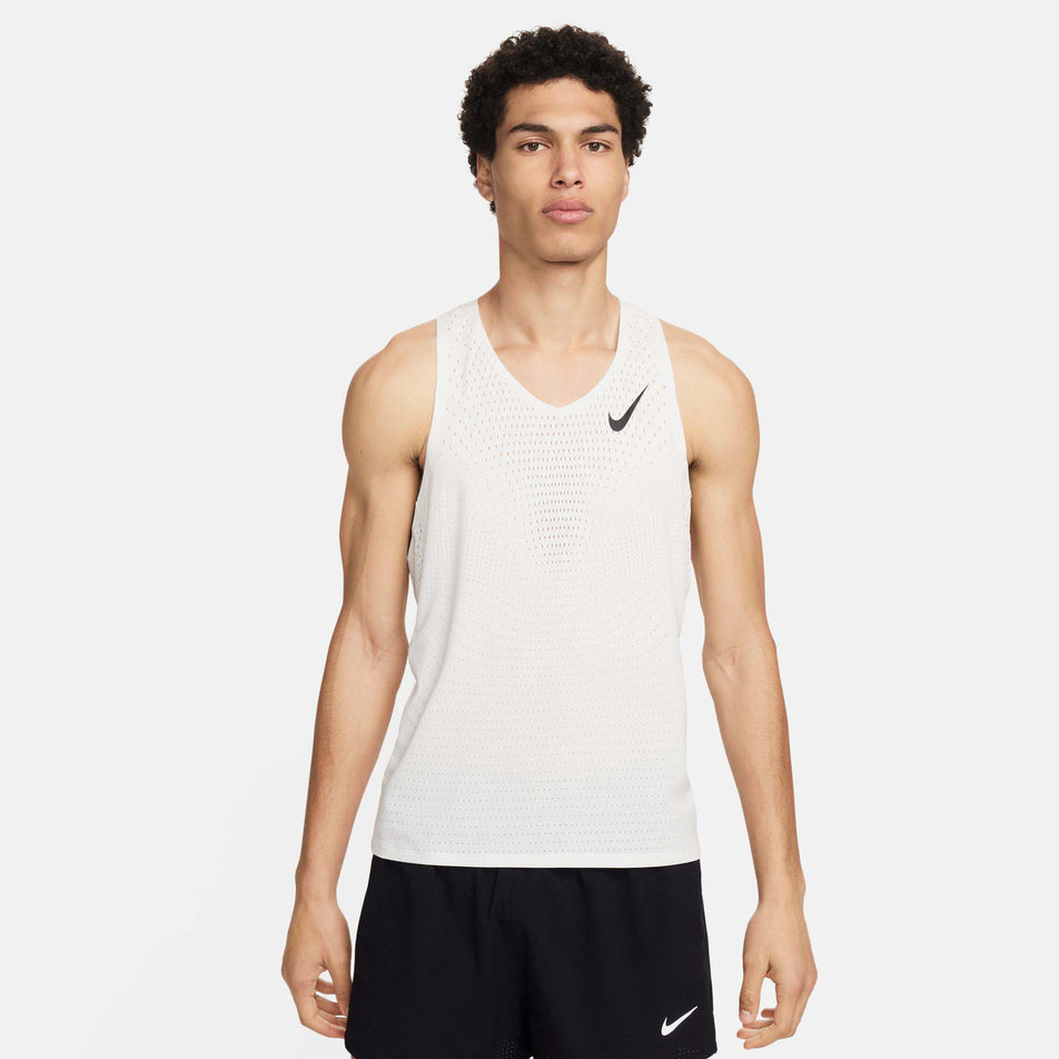 Front view of a model wearing a Nike Men's AeroSwift Dri-FIT ADV Running Singlet in the Summit White/Black colourway. Model is also wearing Nike shorts.  (8186007322786)