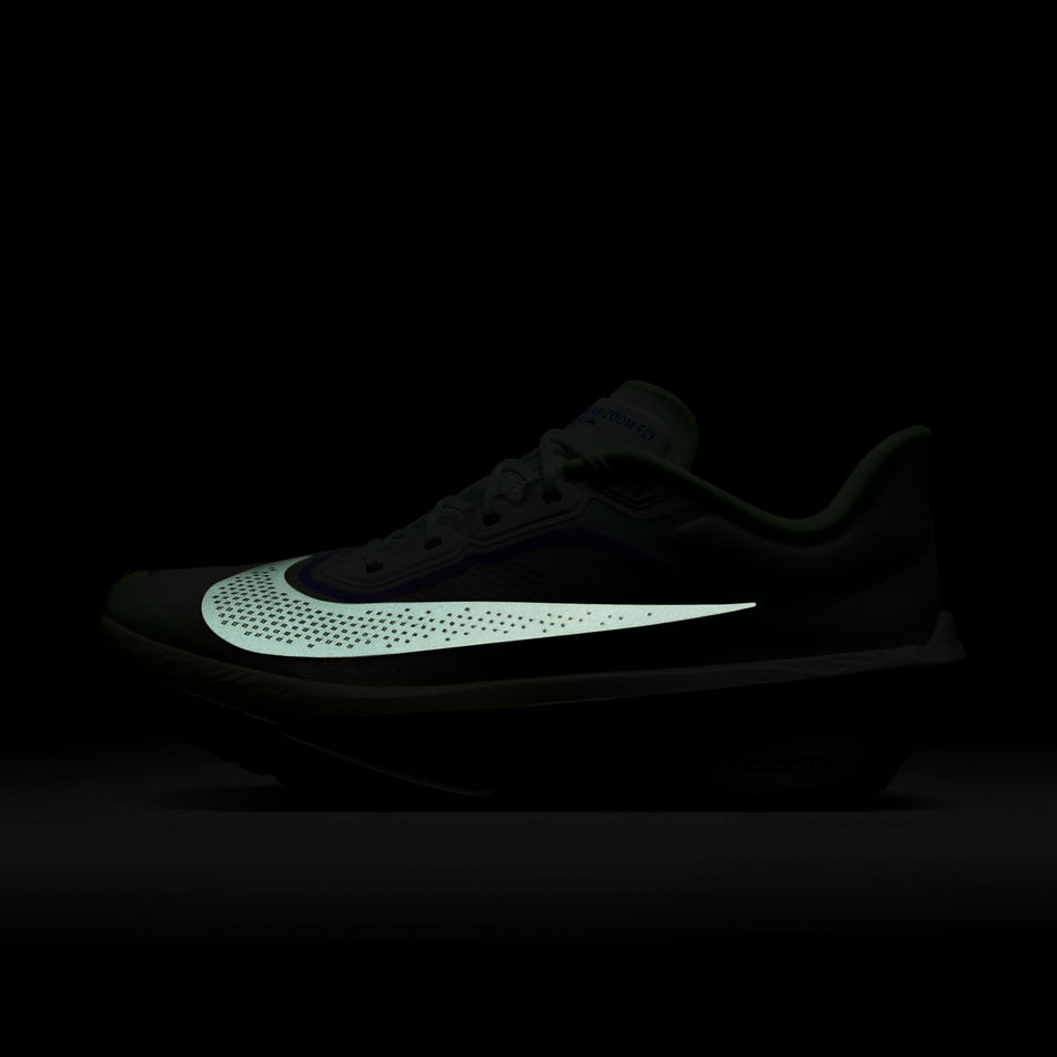 The reflective swoosh on the lateral side of the left shoe from a pair of Nike Men's Zoom Fly 6 Road Running Shoes in the Barely Green/Black Spruce-Volt Ice colourway.