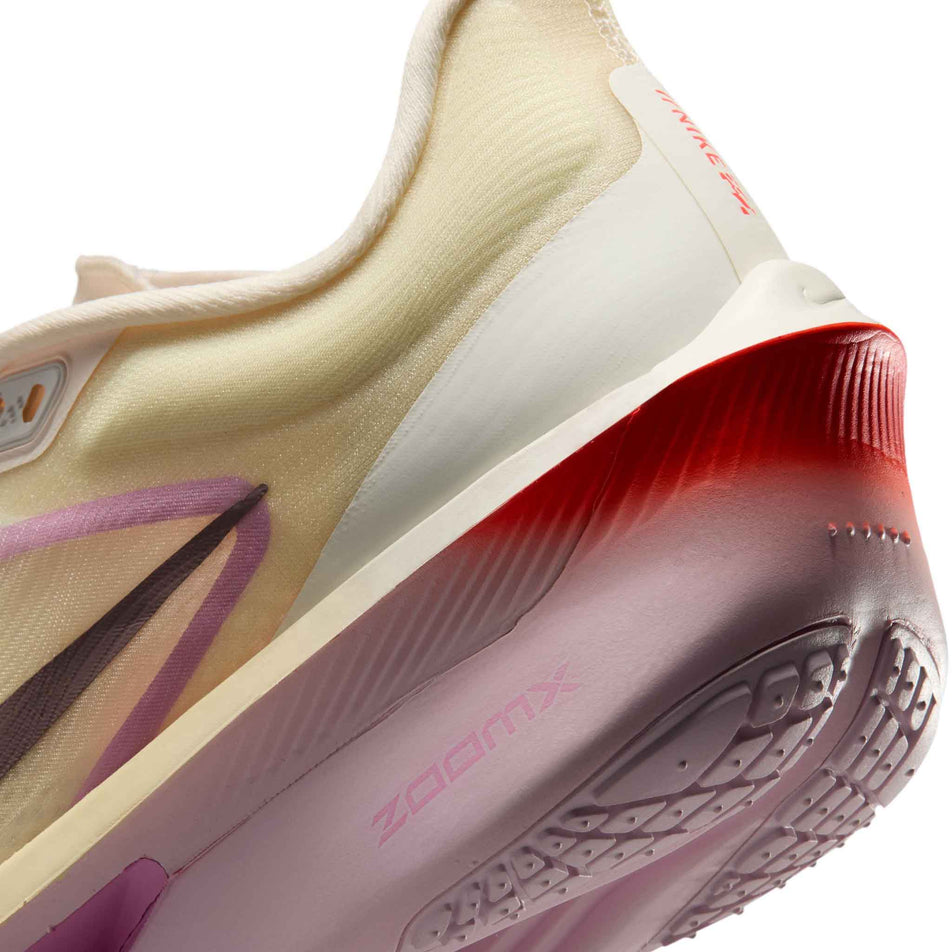 Close-up view of the rearfoot section of the left shoe from a pair of Nike Women's Zoom Fly 6 Road Running Shoes in the Sail/Tattoo-Light Magenta-Pearl Pink colourway.
