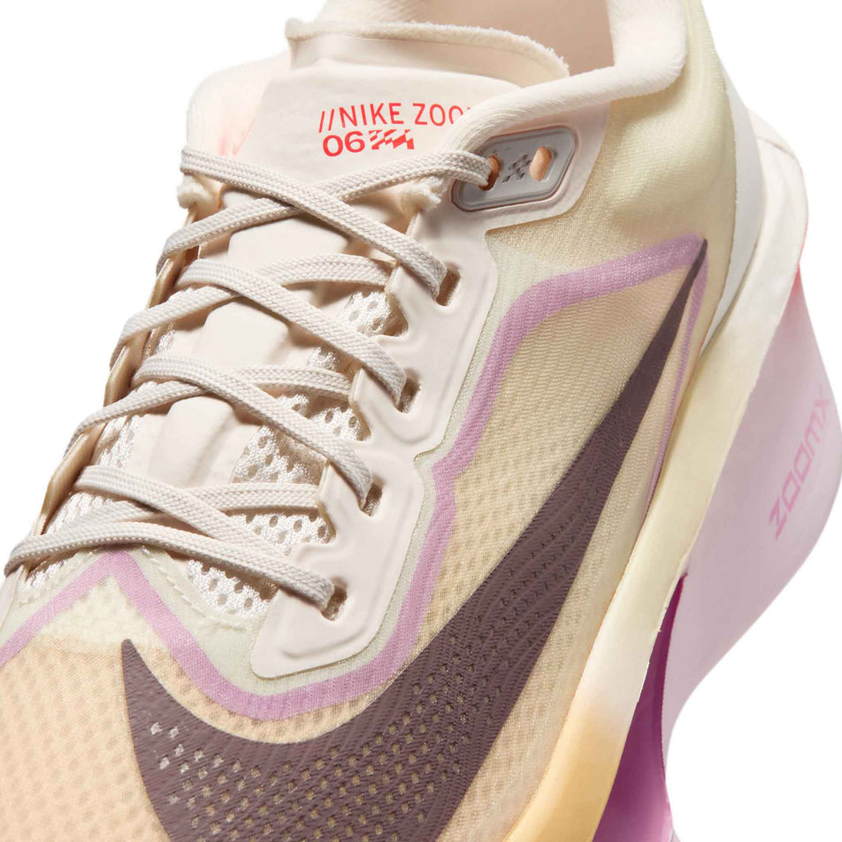 Close-up view of the upper of the left shoe from a pair of Nike Women's Zoom Fly 6 Road Running Shoes in the Sail/Tattoo-Light Magenta-Pearl Pink colourway.