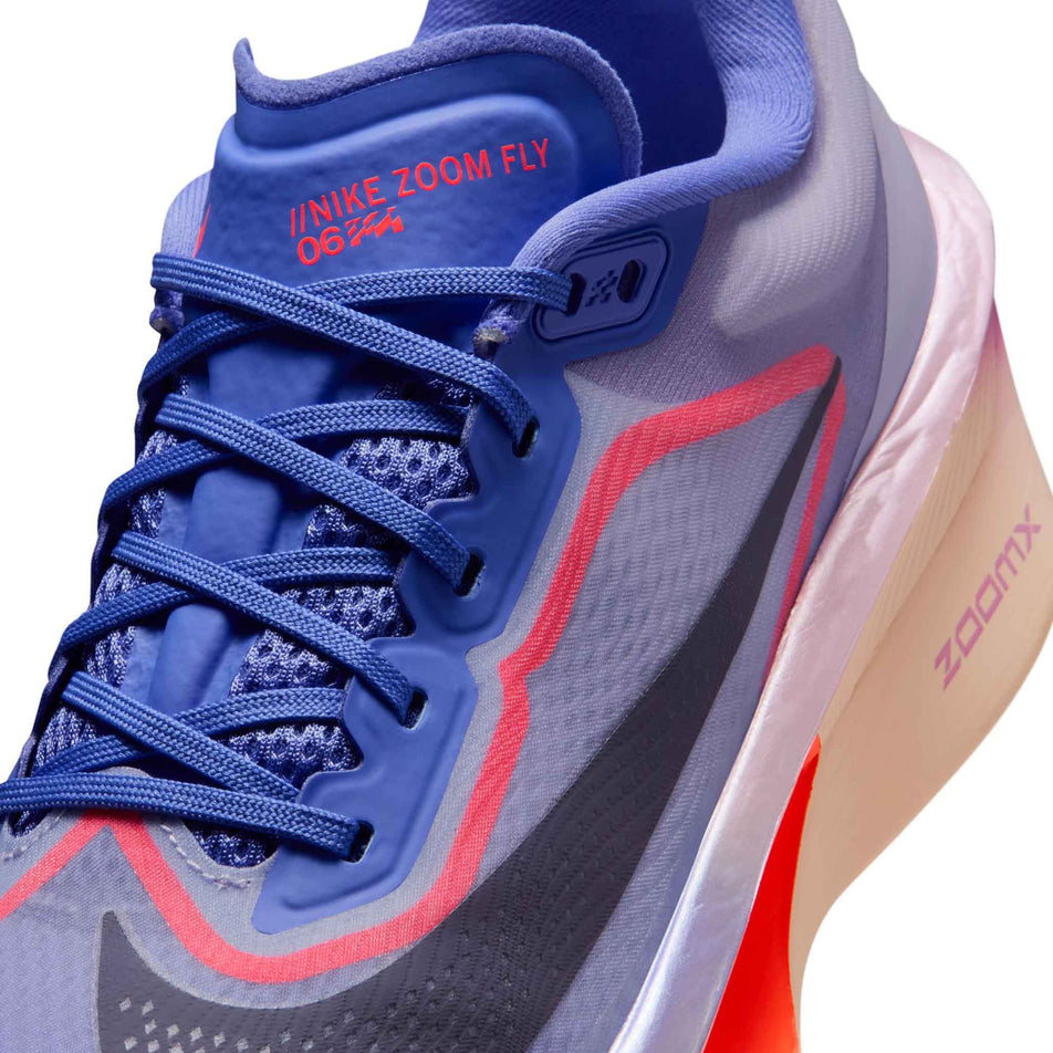 Close-up view of the upper of the left shoe from a pair of Nike Women's Zoom Fly 6 Road Running Shoes in the Violet Mist/Purple Dynasty-Hot Lava colourway.