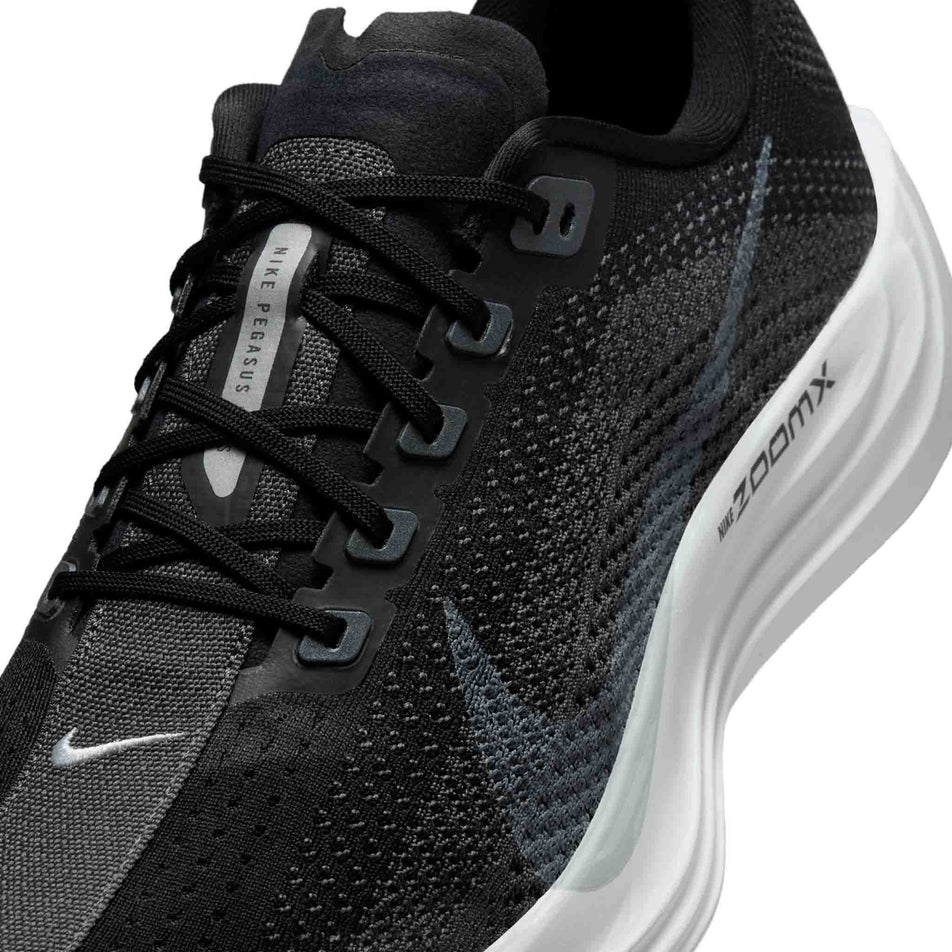 Close up of the upper of the left shoe from a pair of Nike Men's Pegasus Plus Road Running Shoes in the Black/Pure Platinum-Anthracite-White colourway. (8683698192546)