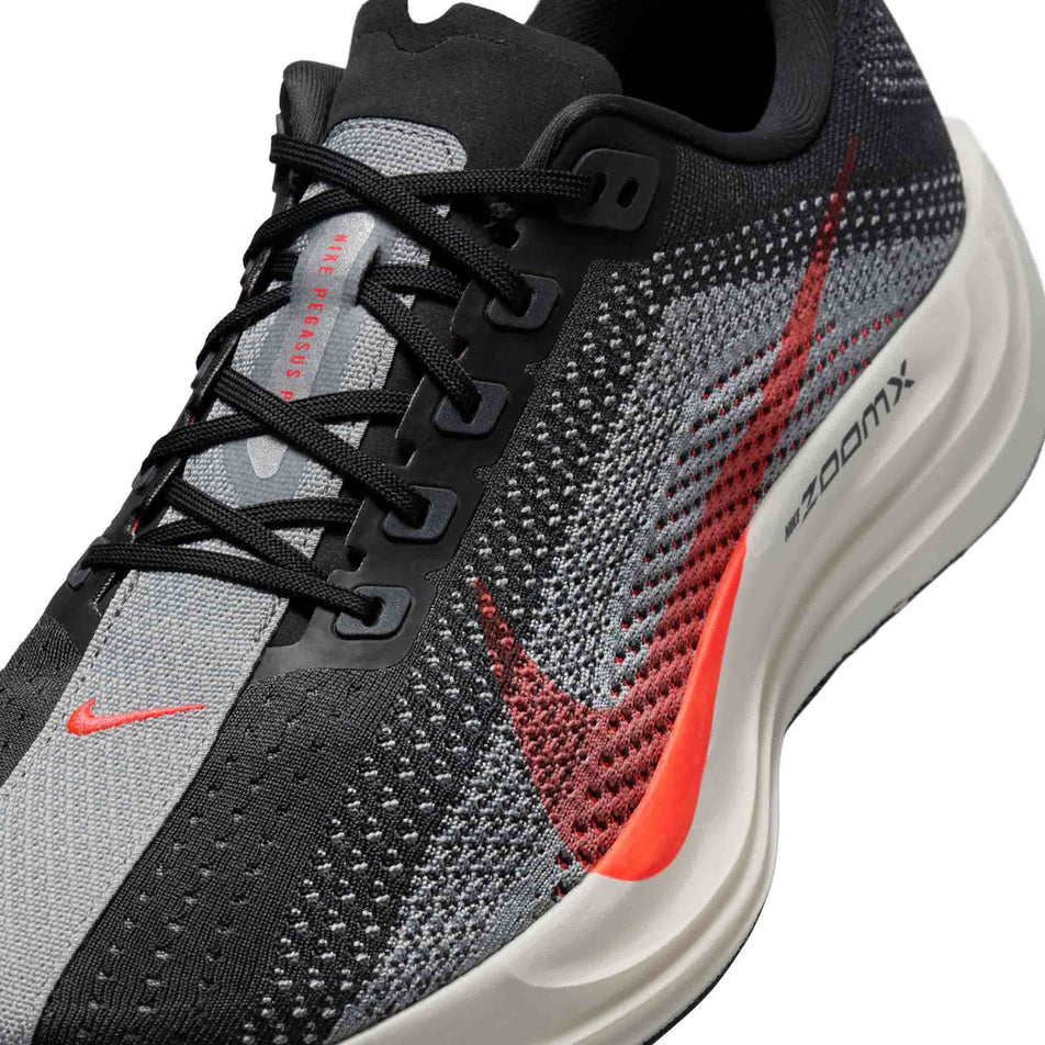 Close up of the upper of the left shoe from a pair of Nike Men's Pegasus Plus Road Running Shoes in the Anthracite/Bright Crimson-Light Smoke Grey colourway. (8683710185634)