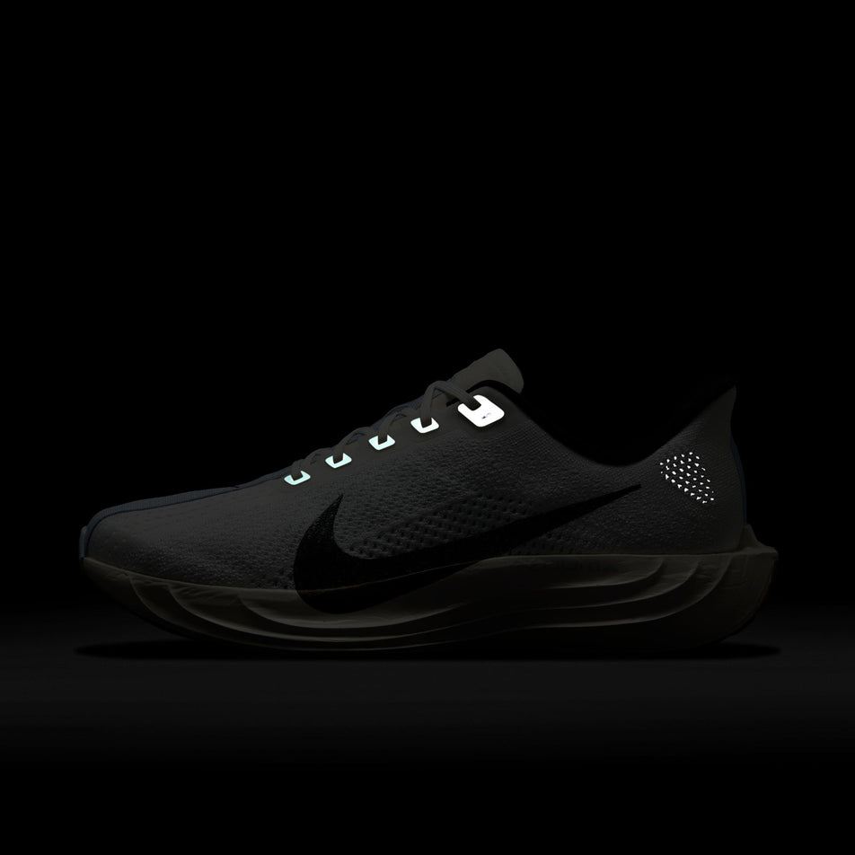 The reflective details on the medial side of the left shoe from a pair of Nike Men's Pegasus Plus Road Running Shoes in the White/Black-Sail-Blue Tint colourway.  (8614356779170)