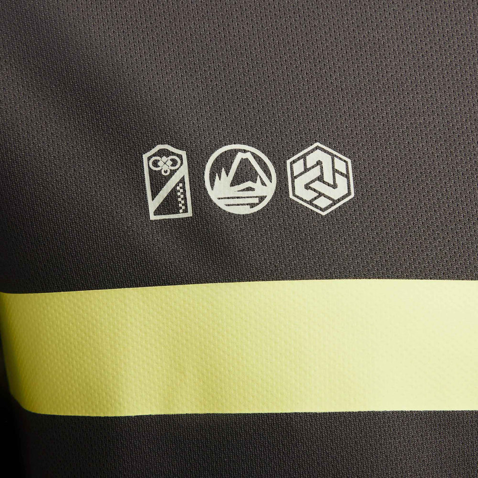 Close-up of the icons on the left-side of the chest on a Nike Men's Miler Dri-FIT UV Short-Sleeve Running Top in the Medium Ash/Luminous Green/Light Bone colourway. (8141458473122)