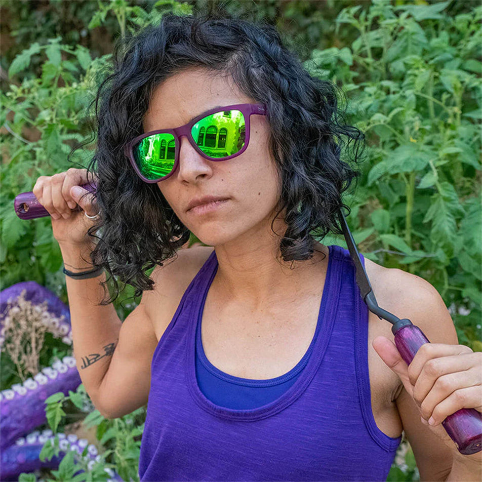 A model wearing a pair of goodr Gardening with a Kraken - OG - Running Sunglasses