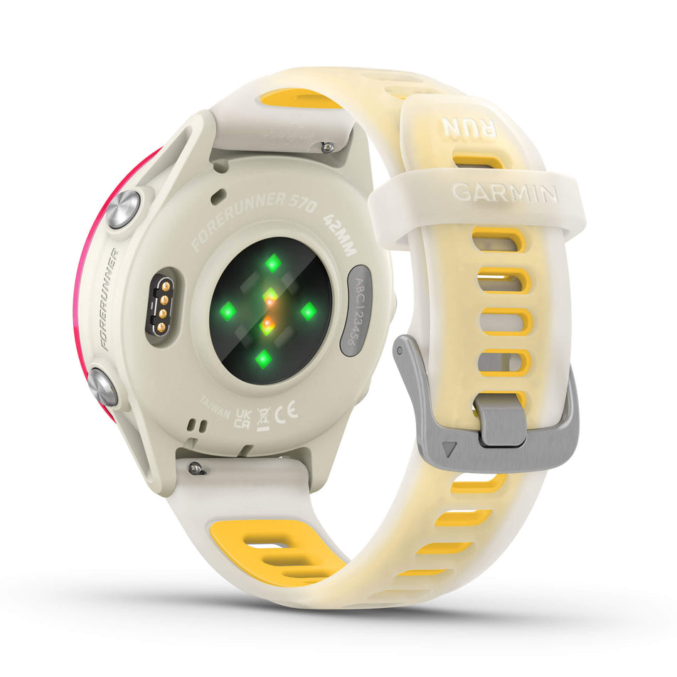 A Garmin Forerunner 570 in the 42mm case size. Raspberry Aluminium with Translucent Bone/Mango Band. Back of watch and wrist-based heart rate monitor. (8692224426146)