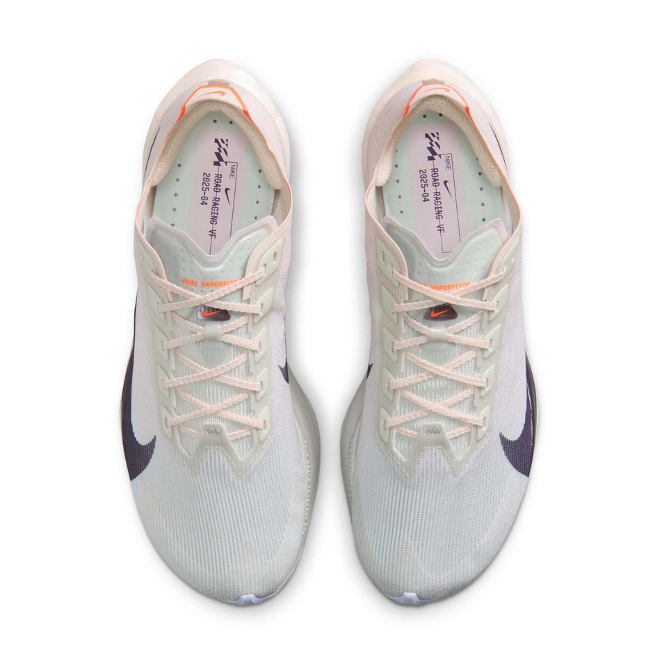 The uppers of a pair of Nike Women's Vaporfly 4 Road Racing Shoes in the Barely Green/Purple Dynasty-Chalk colourway.