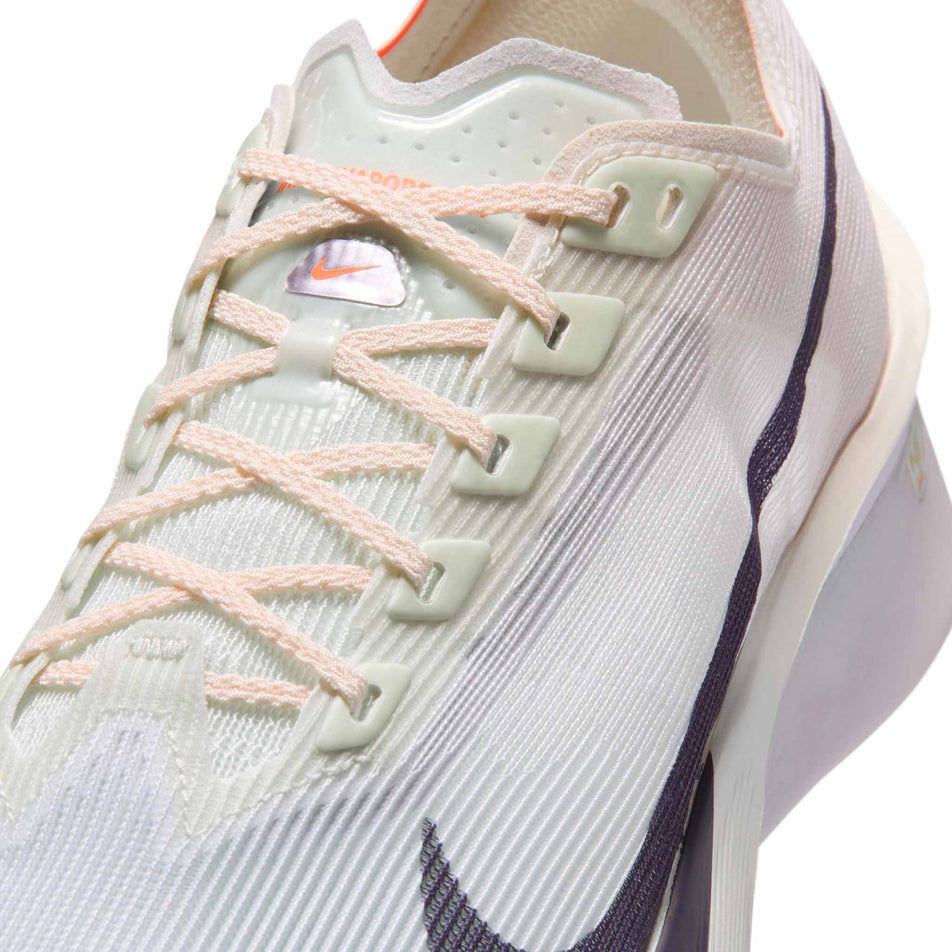 Close-up view of the upper of the left shoe from a pair of Nike Women's Vaporfly 4 Road Racing Shoes in the Barely Green/Purple Dynasty-Chalk colourway.