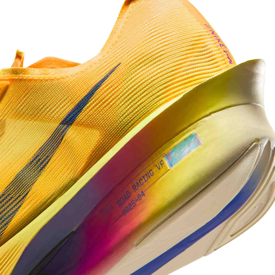 Close-up view of the rearfoot section of the left shoe from a pair of Nike Men's Vaporfly 4 Road Racing Shoes in the Citron Pulse/Indigo Burst-Laser Orange colourway.