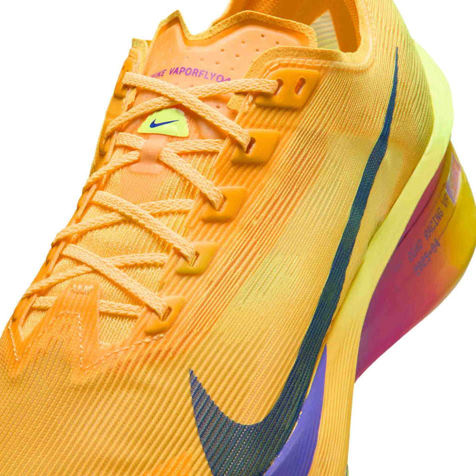 Close-up view of the upper of the left shoe from a pair of Nike Men's Vaporfly 4 Road Racing Shoes in the Citron Pulse/Indigo Burst-Laser Orange colourway.