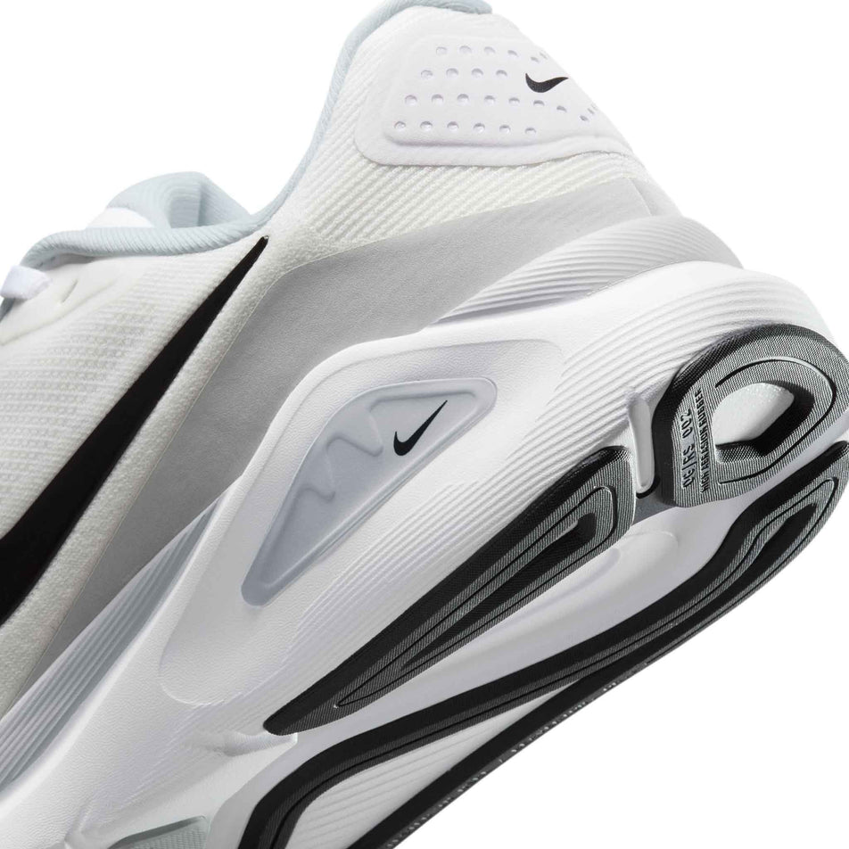 Close-up view of the rearfoot section of the left shoe from a pair of Nike Women's Structure 26 Road Running Shoes in the White/Black-Pure Platinum colourway.