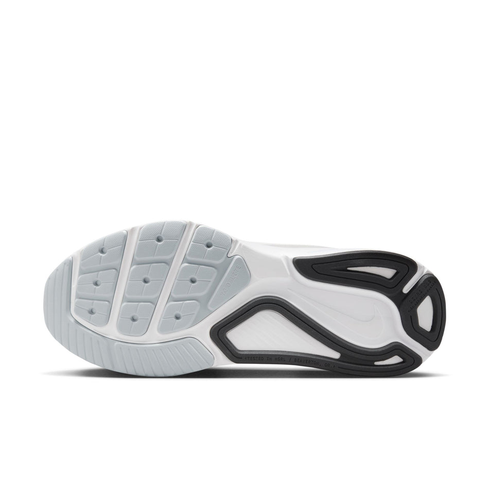 The outsole of the left shoe from a pair of Nike Women's Structure 26 Road Running Shoes in the White/Black-Pure Platinum colourway.