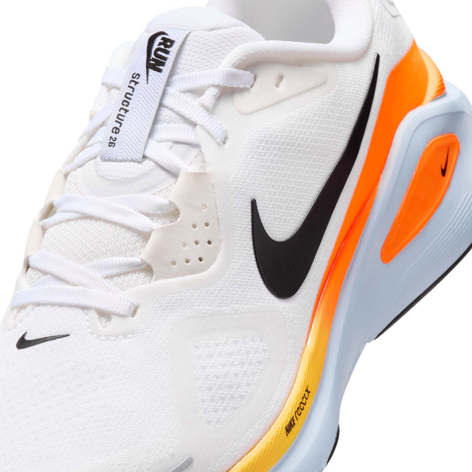 Close-up view of the upper of the left shoe from a pair of Nike Men's Structure 26 Road Running Shoes in the White/Black-Hydrogen Blue-Total Orange colourway.