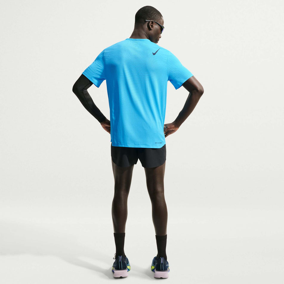 Back view of a model wearing the Nike Men's AeroSwift Dri-FIT ADV Short-Sleeve Running Top in the Light Current Blue/Black colourway.