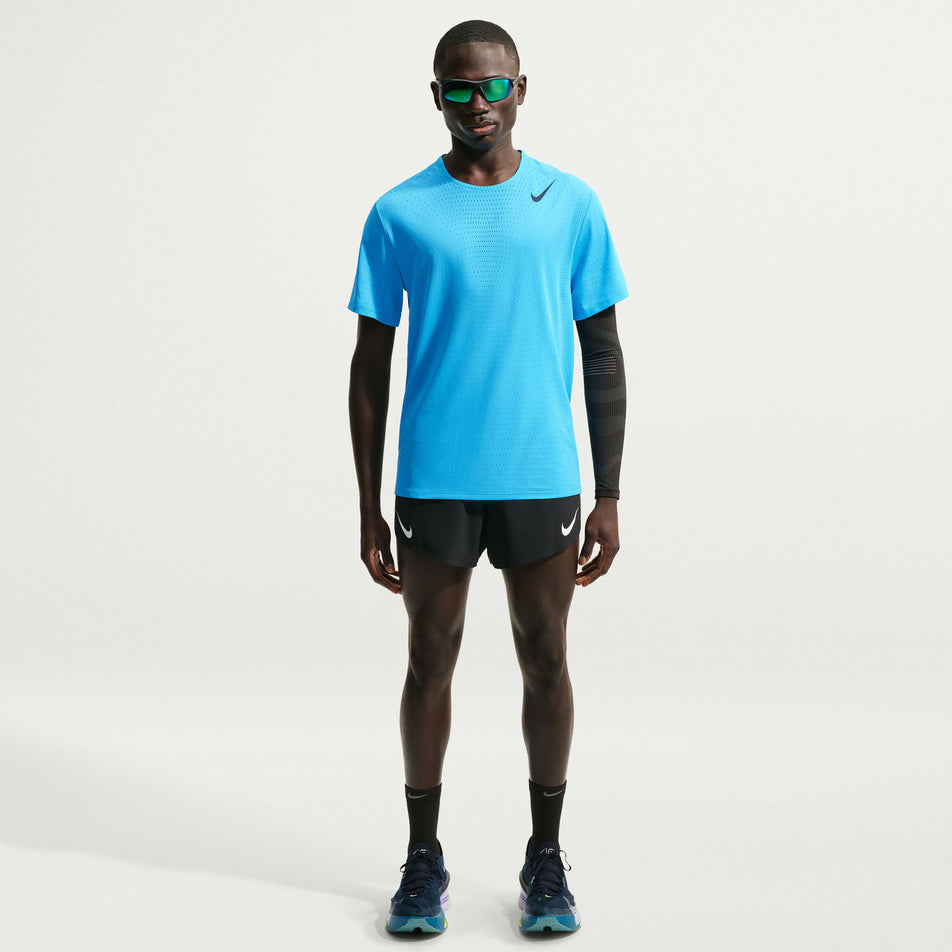 Front view of a model wearing the Nike Men's AeroSwift Dri-FIT ADV Short-Sleeve Running Top in the Light Current Blue/Black colourway.
