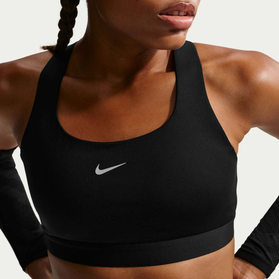 Front view of a model wearing the Nike Women's Swift High-Support Lightly Lined Sports Bra in the Black/Silver colourway.