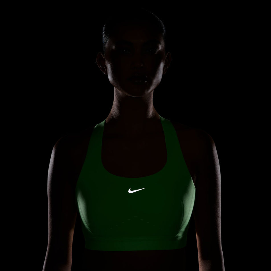 The reflective Swoosh on the front of the Nike Women's Swift High-Support Lightly Lined Sports Bra in the Illusion Green colourway.
