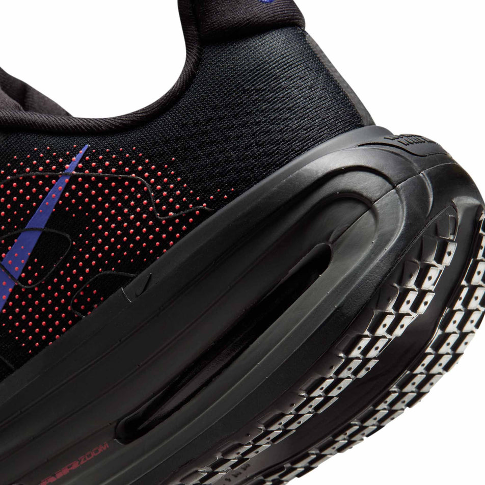 Close-up view of the rearfoot section of the left shoe from a pair of Nike Women's Vomero Premium Road Running Shoes in the Black/Sapphire-Hot Lava-Anthracite colourway.