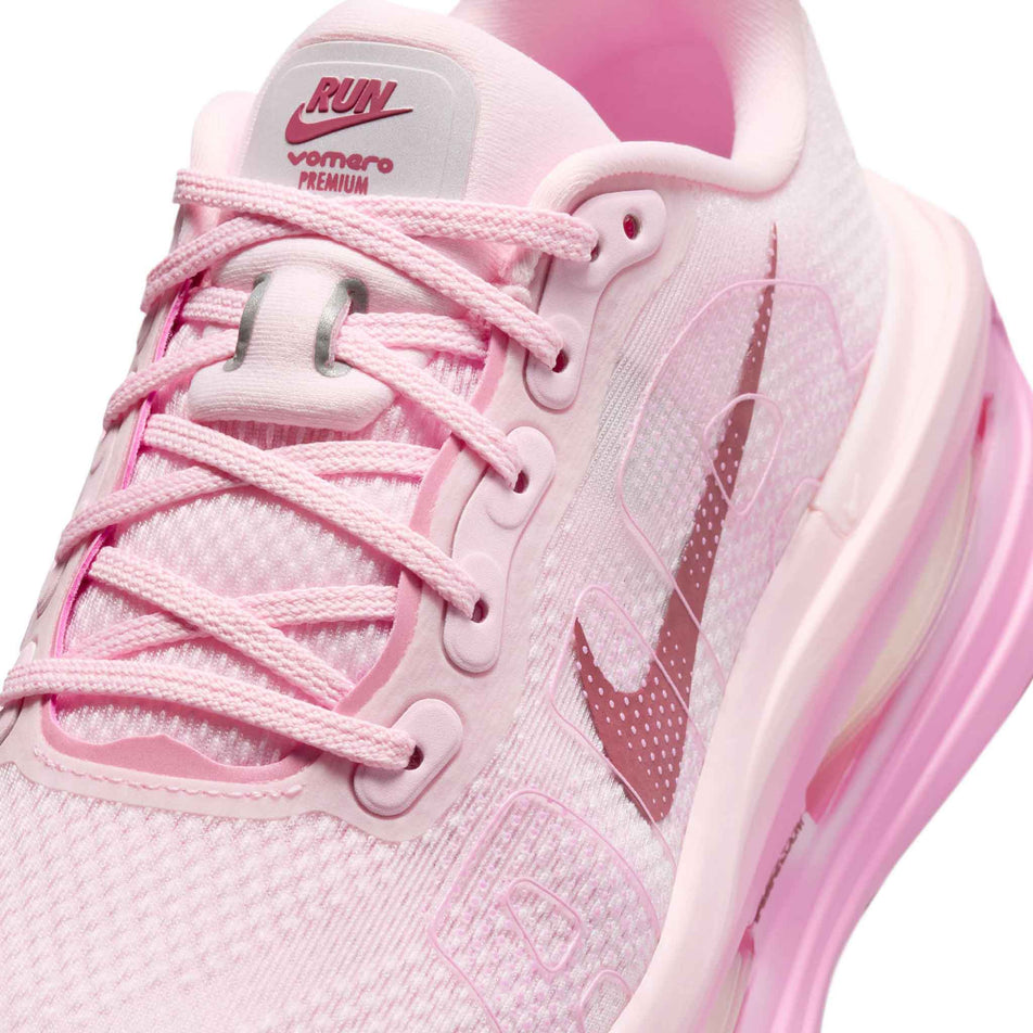 Close-up view of the upper of the left shoe from a pair of Nike Women's Vomero Premium Road Running Shoes in the Pink Foam/Pink Smoke-Pink Rise colourway.