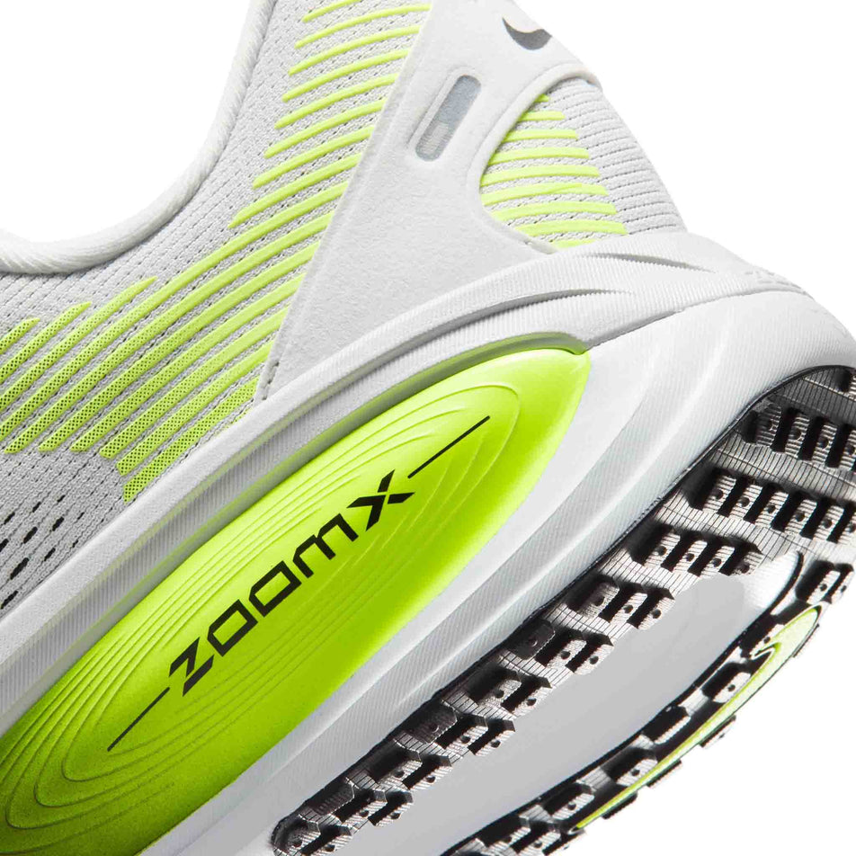 Close-up view of the rearfoot section of the left shoe from a pair of Nike Men's Vomero 18 Road Running Shoes in the Photon Dust/Black-Volt colourway.
