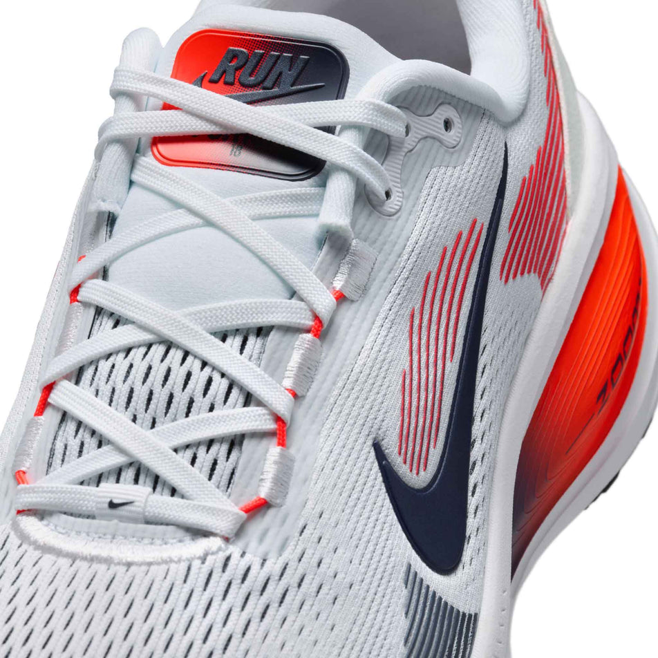 Close-up view of the upper of the left shoe from a pair of Nike Men's Vomero 18 Road Running Shoes in the White/Midnight Navy-Bright Crimson-Black colourway.