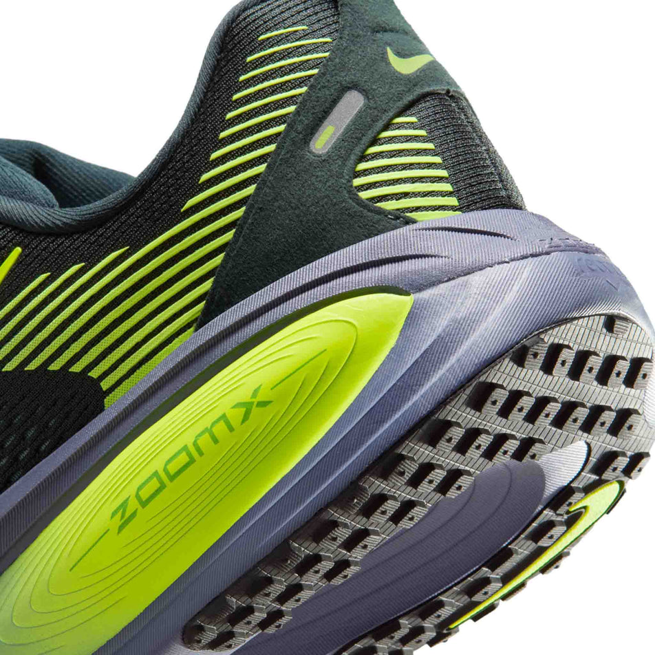 Close-up view of the rearfoot section of the left shoe from a pair of Nike Men's Vomero 18 Road Running Shoes in the Seaweed/Volt-Cannon-Sanded Purple colourway.