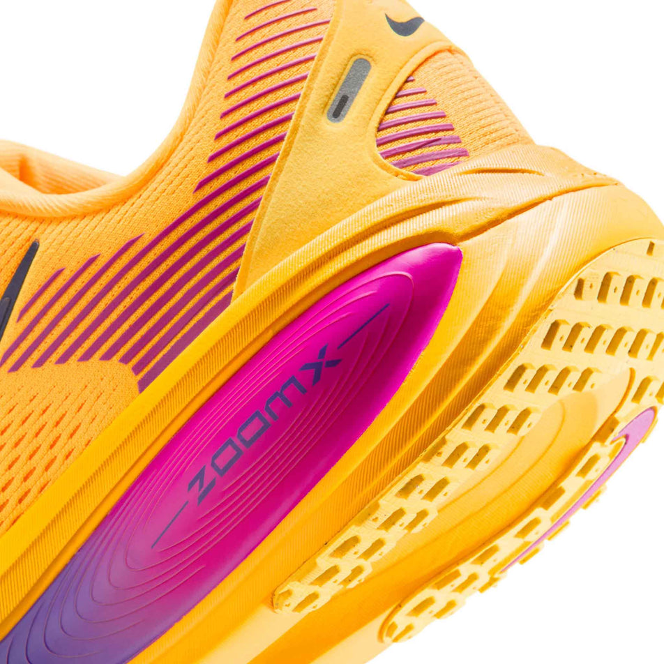 Close-up view of the rearfoot section of the left shoe from a pair of Nike Men's Vomero 18 Road Running Shoes in the Citron Pulse/Blue Void-laser Orange colourway.