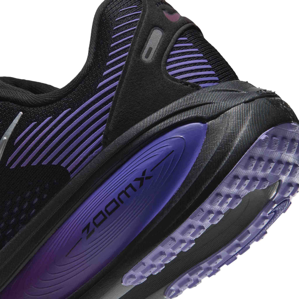 Close-up view of the rearfoot section of the left shoe from a pair of Nike Women's Vomero 18 Road Running Shoes in the Black/Metallic Silver-Persian Violet colourway.