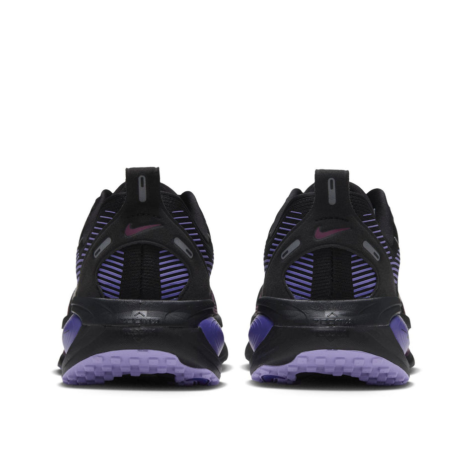 The back of a pair of Nike Women's Vomero 18 Road Running Shoes in the Black/Metallic Silver-Persian Violet colourway.
