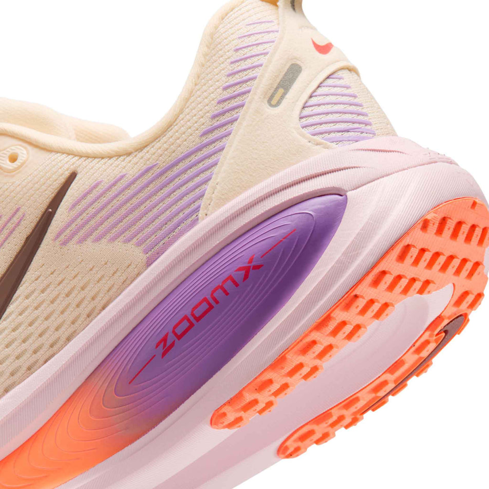 Close-up view of the rearfoot section of the left shoe from a pair of Nike Women's Vomero 18 Road Running Shoes in the Chalk/Tattoo-Pink Foam-Bright Violet colourway.
