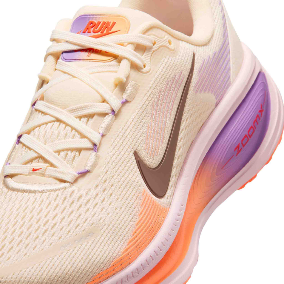 Close-up view of the upper of the left shoe from a pair of Nike Women's Vomero 18 Road Running Shoes in the Chalk/Tattoo-Pink Foam-Bright Violet colourway.
