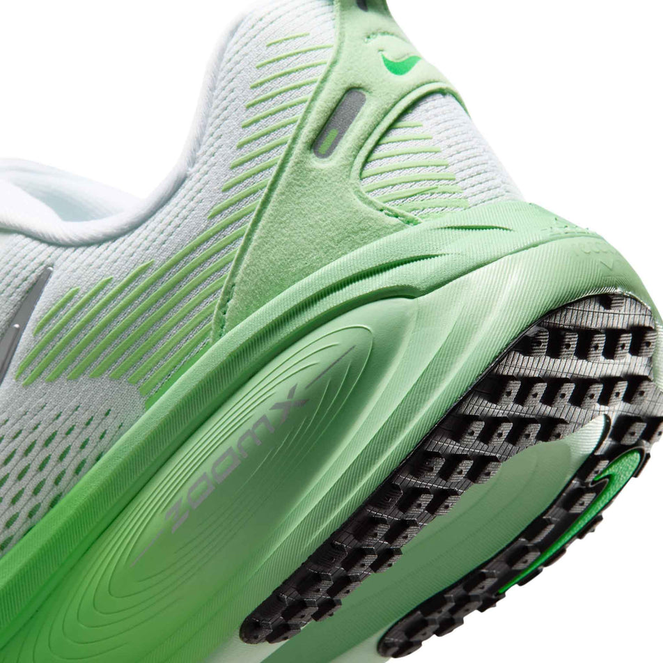 Close-up view of the rearfoot section of the left shoe from a pair of Nike Women's Vomero 18 Road Running Shoes in the White/Metallic Silver-Illusion Green colourway.
