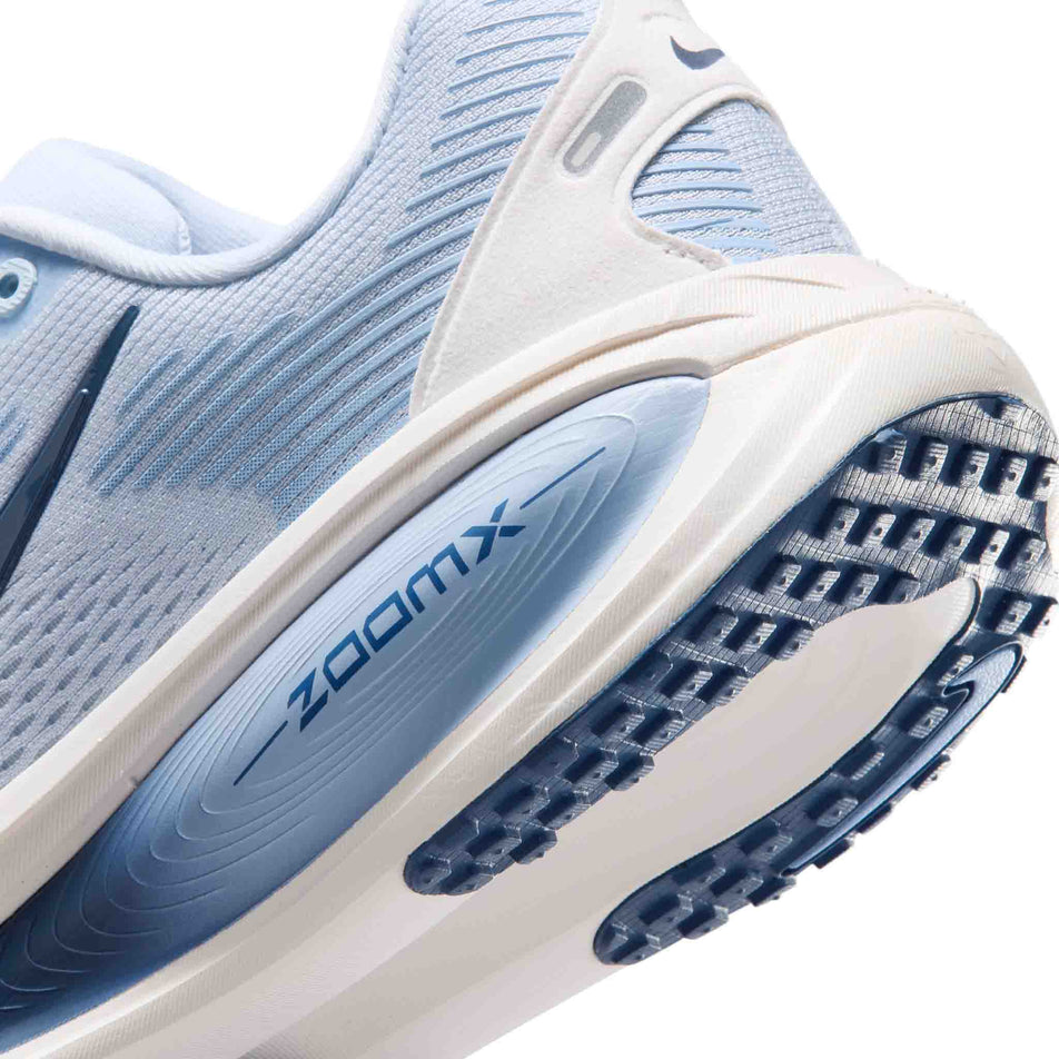 Close-up view of the rearfoot section of the left shoe from a pair of Nike Women's Vomero 18 Road Running Shoes in the Hydrogen Blue/Mystic Navy-Aluminum colourway.