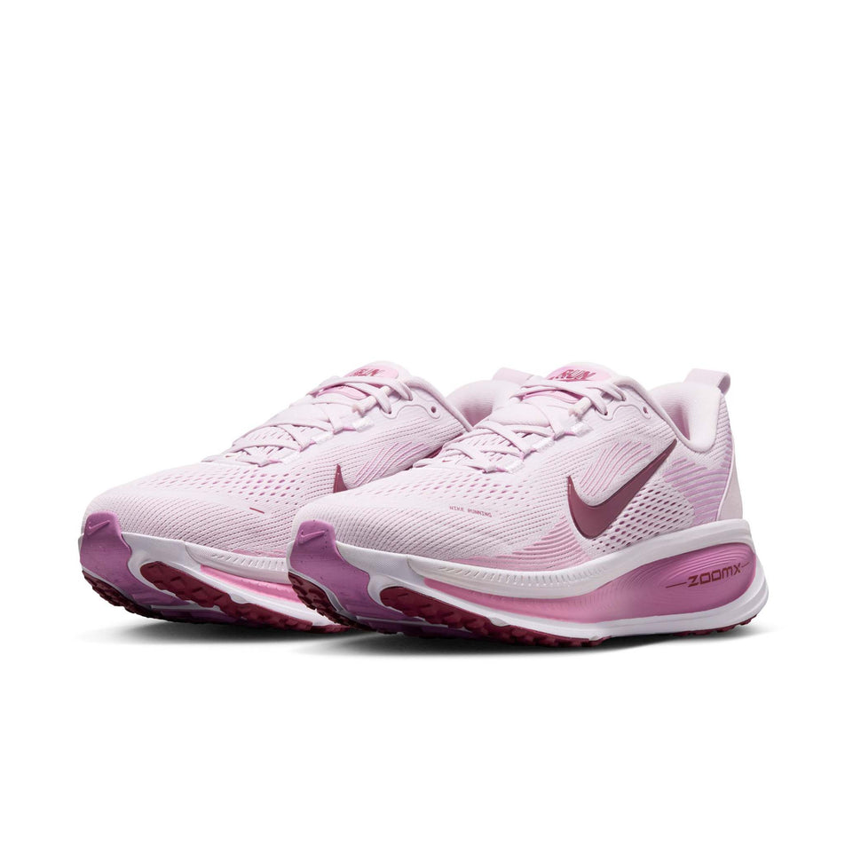 A pair of Nike Women's Vomero 18 Road Running Shoes in the Bleached Lilac/Pink Smoke-Light Magenta colourway.