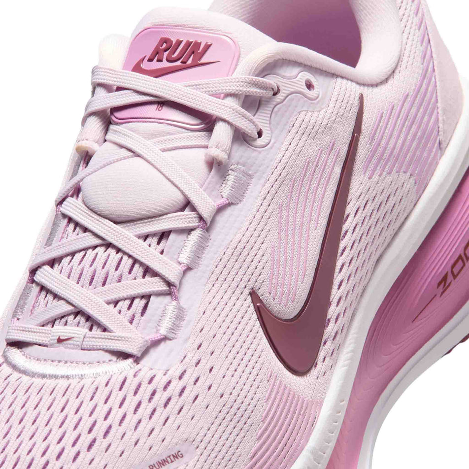 Close-up view of the upper of the left shoe from a pair of Nike Women's Vomero 18 Road Running Shoes in the Bleached Lilac/Pink Smoke-Light Magenta colourway.