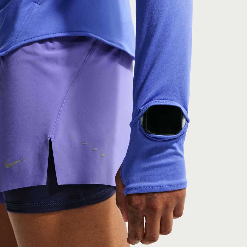 The watch window on the sleeve of the Nike Women's Swift Dri-FIT UV Long-Sleeve Crew-Neck Running Top in the Sapphire/Reflective Silver colourway.