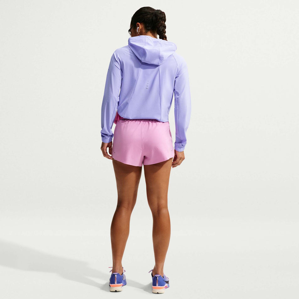 Back view of a model wearing the Nike Women's Swift Repel Packable Running Jacket in the Purple Pulse/Reflective Silver colourway.