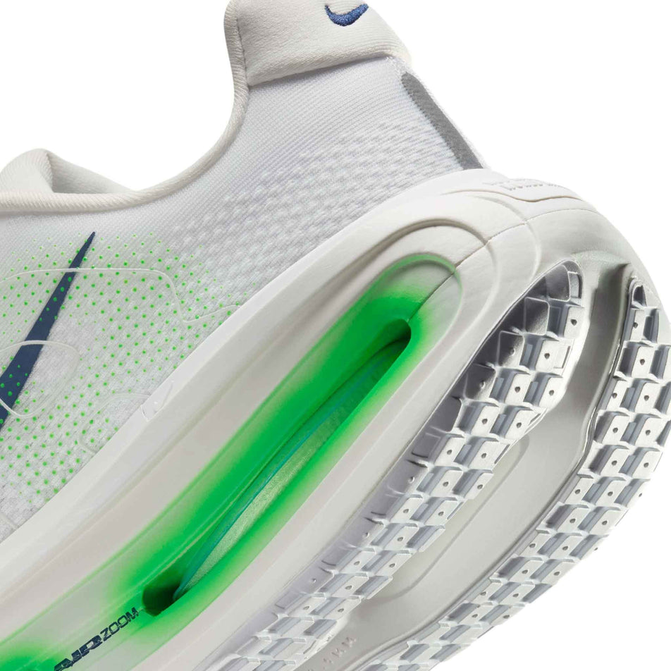 Close-up view of the rearfoot section of the left shoe from a pair of Nike Men's Vomero Premium Road Running Shoes in the White/Midnight Navy-Green Spark colourway.