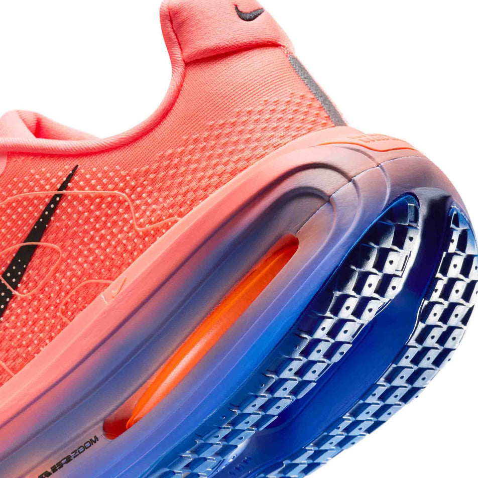 Close-up view of the rearfoot section of the left shoe from a pair of Nike Men's Vomero Premium Road Running Shoes in the Atomic Pink/Black-Racer Blue colourway.