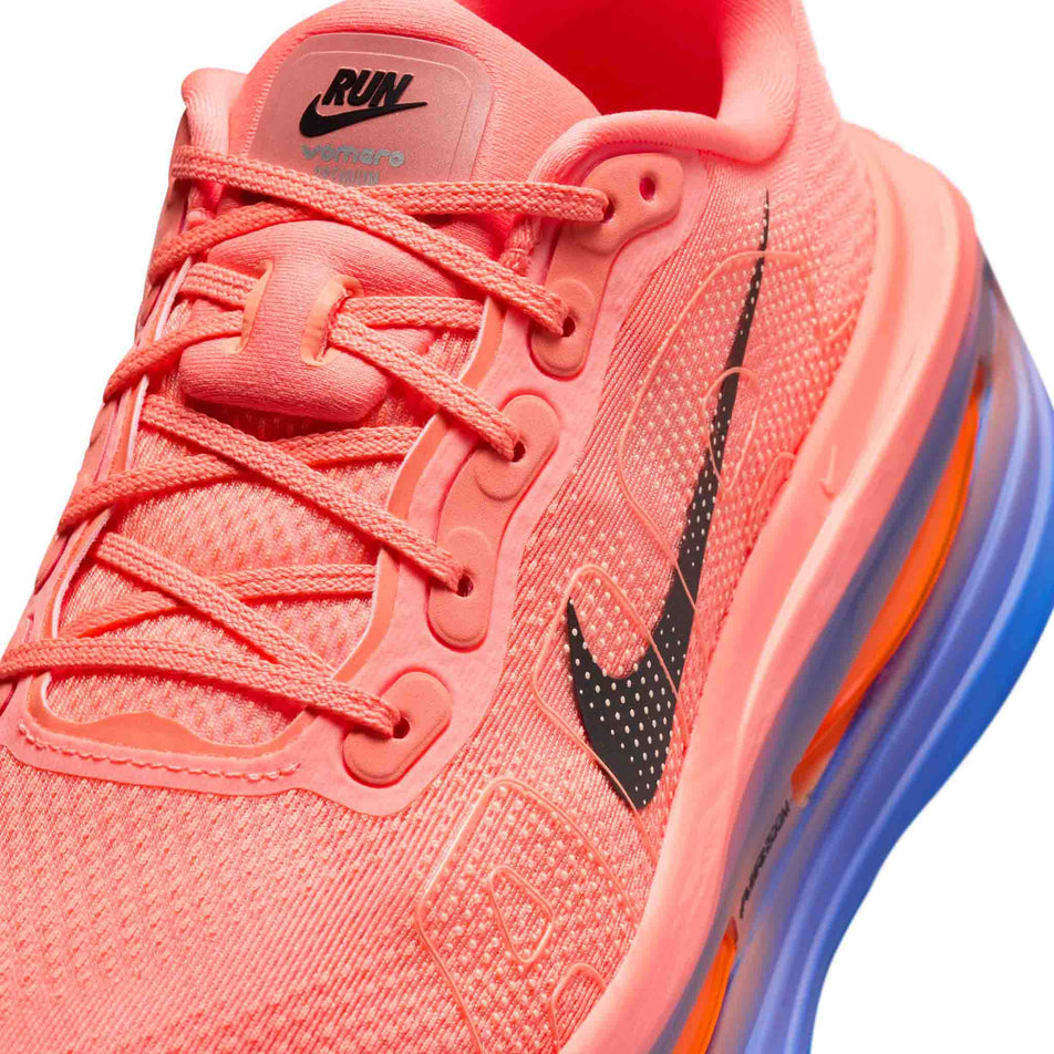Close-up view of the upper of the left shoe from a pair of Nike Men's Vomero Premium Road Running Shoes in the Atomic Pink/Black-Racer Blue colourway.