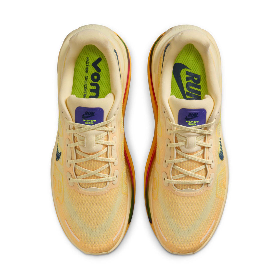 The uppers of a pair of Nike Men's Vomero Premium Road Running Shoes in the Alabaster/Blue Void-Citron Pulse colourway.