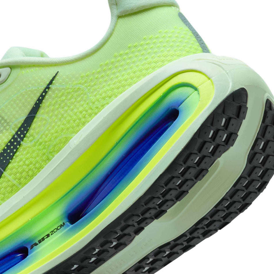 Close-up view of the rearfoot section of the left shoe from a pair of Nike Men's Vomero Premium Road Running Shoes in the Volt Tint/Black Spruce-Sapphire-Volt colourway.