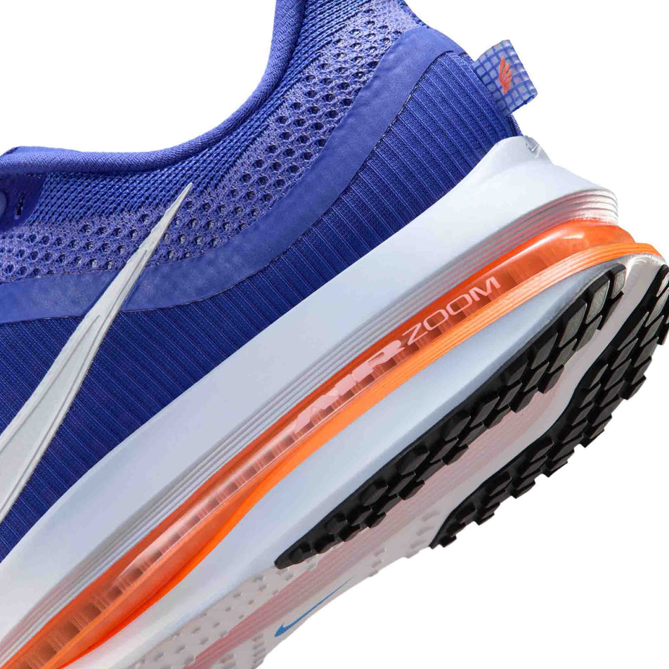 Close-up view of the rearfoot section of the left shoe from a pair of Nike Men's Pegasus Premium Road Running Shoes in the Lapis/White-Total Orange-Off Noir colourway.